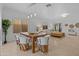 Bright dining area with wood table and white chairs near the kitchen at 17441 N 19Th Run, Phoenix, AZ 85022