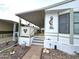 Covered porch with lattice detailing and access to the home at 205 S Higley Rd # 218, Mesa, AZ 85206