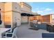 Outdoor kitchen with built-in grill, sink, and seating area at 2211 E Camelback Rd # 607, Phoenix, AZ 85016