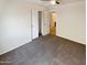 Bedroom with carpeted floors and access to bathroom at 23218 W Hopi St, Buckeye, AZ 85326