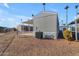 Rear view of manufactured home with AC unit and gravel lot at 2701 E Allred Ave # 143, Mesa, AZ 85204