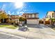 Two-story house with stone accents, landscaped yard, and a three-car garage at 29752 N 69Th Dr, Peoria, AZ 85383