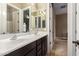 Shared bathroom with double sinks and dark brown cabinets at 3234 E Ian Dr, Phoenix, AZ 85042