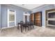 Bright dining room with a modern table and chairs, built-in shelving, and a stylish chandelier at 3234 E Ian Dr, Phoenix, AZ 85042