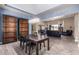 Open dining room with dark wood table and chairs, view into living room at 3234 E Ian Dr, Phoenix, AZ 85042