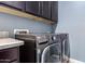 Laundry room with dark brown cabinets and LG washer and dryer at 3234 E Ian Dr, Phoenix, AZ 85042