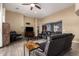 Open living room with comfortable seating, a large TV, and wood-look tile flooring at 3234 E Ian Dr, Phoenix, AZ 85042