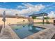 Inviting swimming pool with stone coping and pergola at 3234 E Ian Dr, Phoenix, AZ 85042