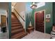 Inviting entryway with wooden staircase and decorative accents at 405 W Fellars Dr, Phoenix, AZ 85023