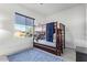 Bedroom with a bunk bed, large window, and gray wood-look flooring at 40512 N Candlewyck Ln, Phoenix, AZ 85086