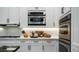 Stainless steel appliances and white shaker cabinets in a well-lit kitchen at 40512 N Candlewyck Ln, Phoenix, AZ 85086