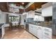 Kitchen with white cabinets, slate tile backsplash, and stainless steel appliances at 5709 E Beck Ln, Scottsdale, AZ 85254