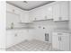 Bright laundry room with white cabinets and patterned tile at 6425 S Rockford Dr, Tempe, AZ 85283