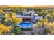 Aerial view of a stunning home with a pool and beautifully landscaped grounds at 6945 E Ashler Hills Dr, Scottsdale, AZ 85266