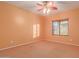 Bright bedroom with ceiling fan and carpeted floor at 7017 W Branham Ln, Laveen, AZ 85339