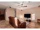 Spacious living room featuring a large TV and comfortable leather seating at 7017 W Branham Ln, Laveen, AZ 85339