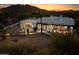 Night view of a beautiful white home with mountain views at 7614 E Rocking Chair Rd, Carefree, AZ 85377