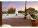 Fireplace nestled in a white stucco wall on a brick patio at 7614 E Rocking Chair Rd, Carefree, AZ 85377