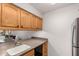 View of a kitchen with wood cabinets, a gray countertop, and stainless steel appliances at 7625 E Camelback Rd # 130A, Scottsdale, AZ 85251