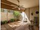 Private patio with seating area, ceiling fan, and lush landscaping at 7625 E Camelback Rd # 130A, Scottsdale, AZ 85251