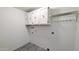 Laundry room with white cabinets, hanging rack, and washer/dryer hookups at 9330 E Kalil Dr, Scottsdale, AZ 85260