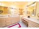 Elegant Primary bathroom with double vanity and large mirrors at 10723 E Navajo Pl, Sun Lakes, AZ 85248