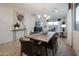 Open dining room with live edge table, modern chandelier, and access to kitchen at 14582 W Valentine St, Surprise, AZ 85379