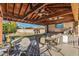 Outdoor patio with built-in kitchen and dining area, covered by a wood pergola at 17638 N 36Th Ave, Glendale, AZ 85308