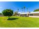 Large backyard with grassy area and partial view of home at 18001 N 99Th Dr, Sun City, AZ 85373