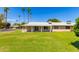 View of the back of the house and the surrounding lawn at 18001 N 99Th Dr, Sun City, AZ 85373