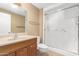 Bathroom with wood vanity, toilet, and large shower at 18001 N 99Th Dr, Sun City, AZ 85373