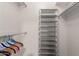 Closet with hanging rod and multi-tiered shelving unit at 18001 N 99Th Dr, Sun City, AZ 85373