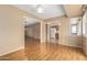 Dining area with hardwood floors, kitchen access, and view to backyard at 18001 N 99Th Dr, Sun City, AZ 85373