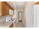 Kitchen with oak cabinets, white appliances, and granite countertops at 18001 N 99Th Dr, Sun City, AZ 85373