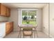 Kitchen features oak cabinets, and a view to the backyard at 18001 N 99Th Dr, Sun City, AZ 85373