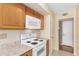White appliances and oak cabinets in this kitchen at 18001 N 99Th Dr, Sun City, AZ 85373