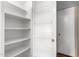 White pantry with wire shelving and ample storage space at 18001 N 99Th Dr, Sun City, AZ 85373