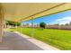 Covered patio with a view of the grassy backyard at 18001 N 99Th Dr, Sun City, AZ 85373