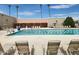 Community pool with lounge chairs and swimmers at 18001 N 99Th Dr, Sun City, AZ 85373