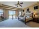 Main bedroom with ceiling fan, large window, and patio access at 1820 W Magdalena Ln, Phoenix, AZ 85041