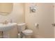 Clean and updated bathroom with pedestal sink and toilet at 20525 W Lost Creek E Dr, Buckeye, AZ 85396