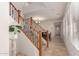 Elegant entryway with staircase, tile flooring, and a plant on a pedestal at 20525 W Lost Creek E Dr, Buckeye, AZ 85396