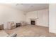 Living room with fireplace, neutral carpet, and two comfy armchairs at 20525 W Lost Creek E Dr, Buckeye, AZ 85396