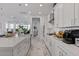 Modern kitchen with white cabinets and island at 2130 E Flamingo Way, Gilbert, AZ 85297