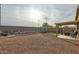 Large backyard with gravel, trampoline, and patio cover at 25763 W Satellite Ln, Buckeye, AZ 85326
