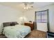 Bright bedroom with a queen bed, dresser, and window coverings at 25763 W Satellite Ln, Buckeye, AZ 85326