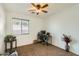 Bedroom with carpeted floor, ceiling fan and a workspace at 25763 W Satellite Ln, Buckeye, AZ 85326