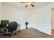Bright bedroom with carpeted floor, ceiling fan and sliding door at 25763 W Satellite Ln, Buckeye, AZ 85326