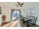 Dining room with glass table, six chairs, and view of backyard at 25763 W Satellite Ln, Buckeye, AZ 85326