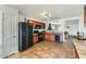 Kitchen with brown cabinets, black appliances, and tile floor at 25763 W Satellite Ln, Buckeye, AZ 85326